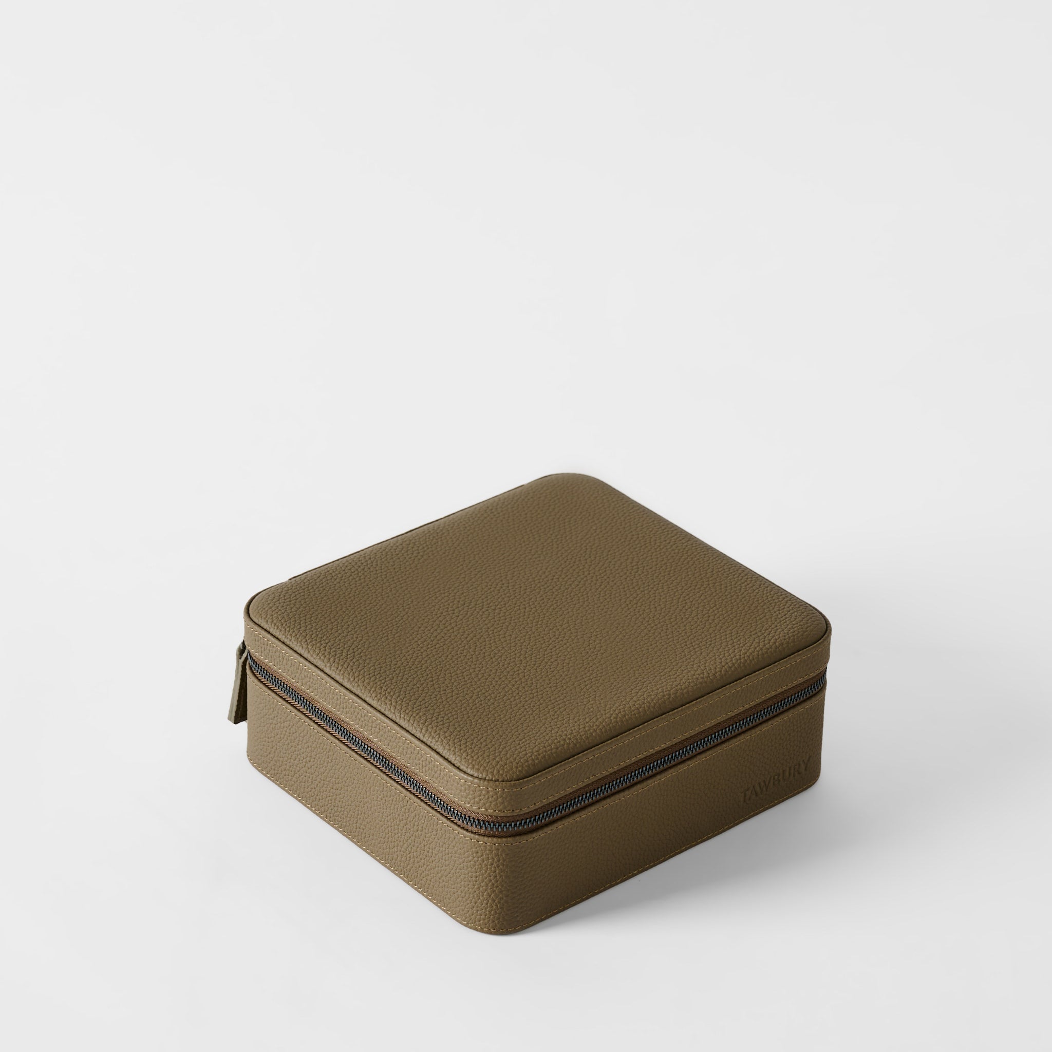 The TAWBURY Fraser 6 Watch Case in Truffle Taupe is a sleek, square leather box on a white surface, elegantly organizing up to six watches.