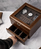 A person is holding a Bayswater 3 Watch Jewellery Box - Brown in a TAWBURY watch box.