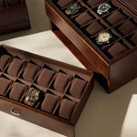 The TAWBURY Bayswater 24 Slot Watch Box with Drawer in brown offers elegant storage for multiple watches, displayed on a beige surface under soft lighting.