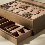 The TAWBURY Bayswater 12 Slot Watch Box with Storage in taupe features a glass lid for displaying your watches and an open lower drawer for storing interchangeable straps and accessories.