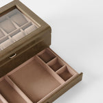 The TAWBURY Bayswater 12 Slot Watch Box with Storage in taupe features a glass lid and multiple compartments for organized watch and accessory storage.