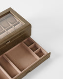 The TAWBURY Bayswater 12 Slot Watch Box with Storage in taupe features a glass lid and multiple compartments for organized watch and accessory storage.