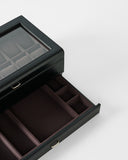 The TAWBURY Bayswater 12 Slot Watch Box with Storage in Black/Charcoal features a glass lid and multiple compartments, shown open on a white background.
