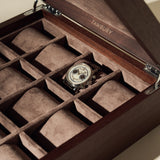 A single wristwatch is shown in the TAWBURY Grove 12 Slot Wooden Watch Box, crafted from dark walnut wood with a solid lid and suede-lined compartments—ideal for organizing your collection.