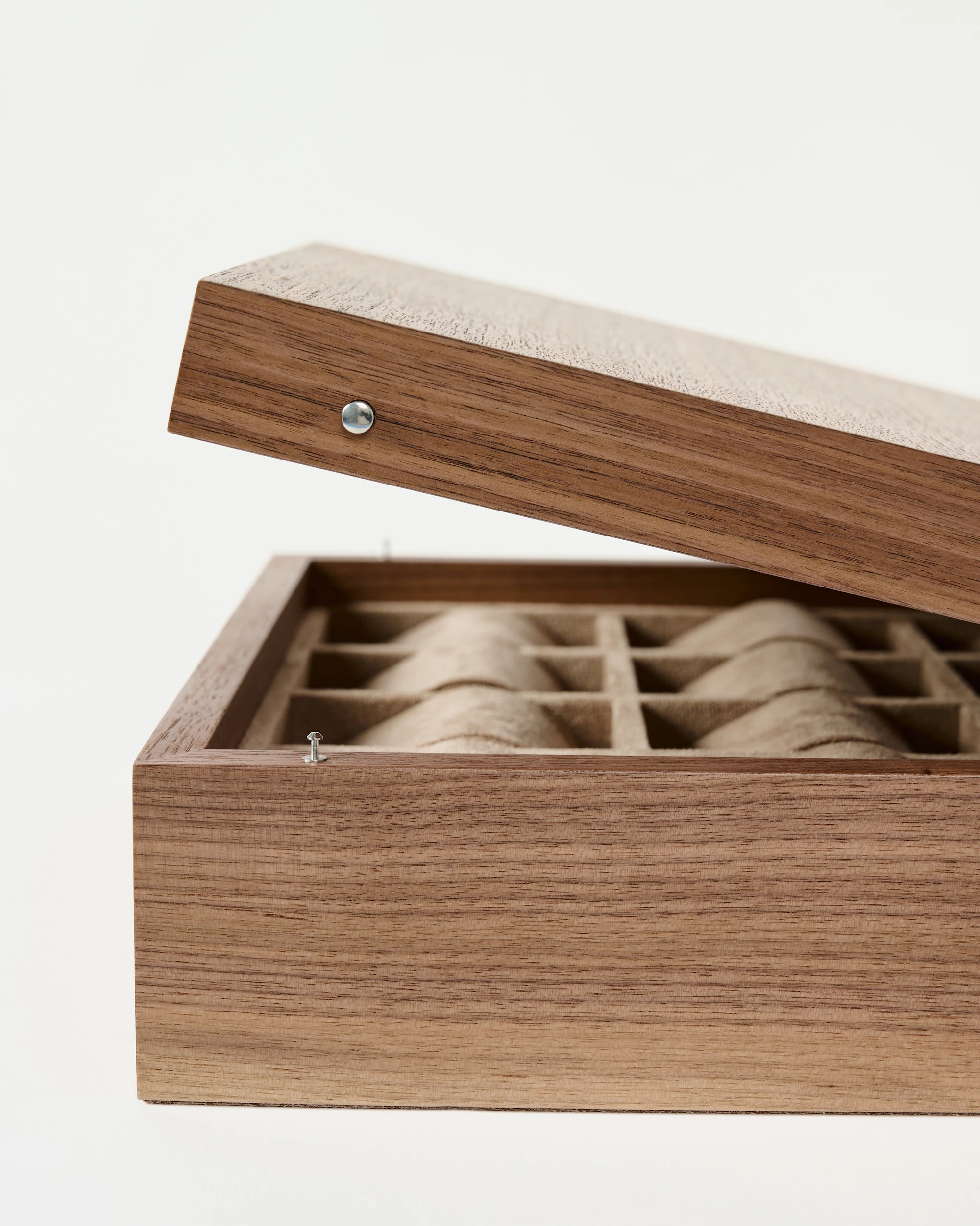 The TAWBURY Grove 12 Slot Wooden Watch Box in light walnut features a solid lid and neatly organized compartments, making it an elegant storage solution for watches, shown against a plain background.