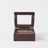 The TAWBURY Grove 6 Slot Wooden Watch Box in Dark Walnut features a glass lid and soft-lined compartments, creating an elegant display case to showcase and protect your watch collection.
