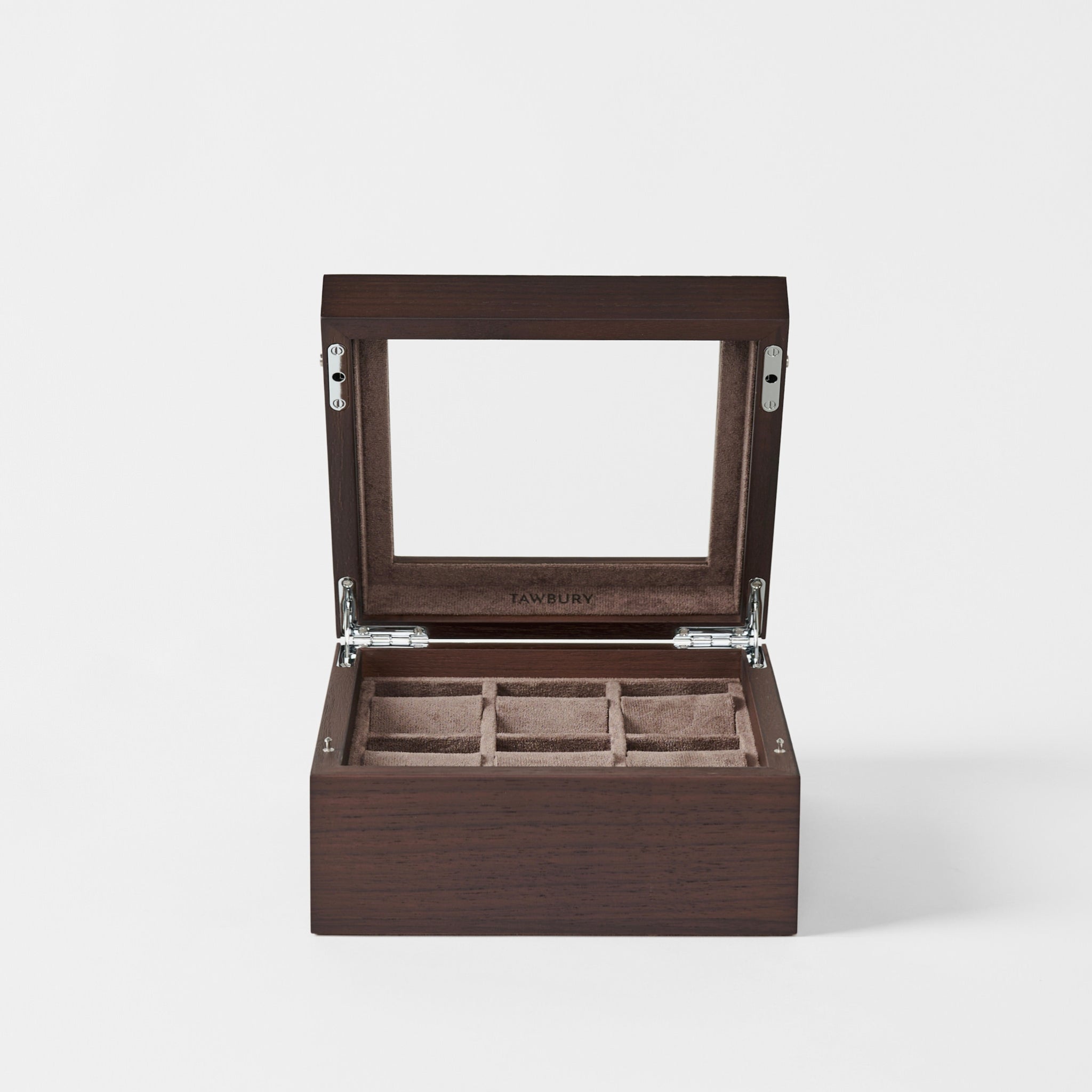 The TAWBURY Grove 6 Slot Wooden Watch Box in Dark Walnut features a glass lid and soft-lined compartments, creating an elegant display case to showcase and protect your watch collection.
