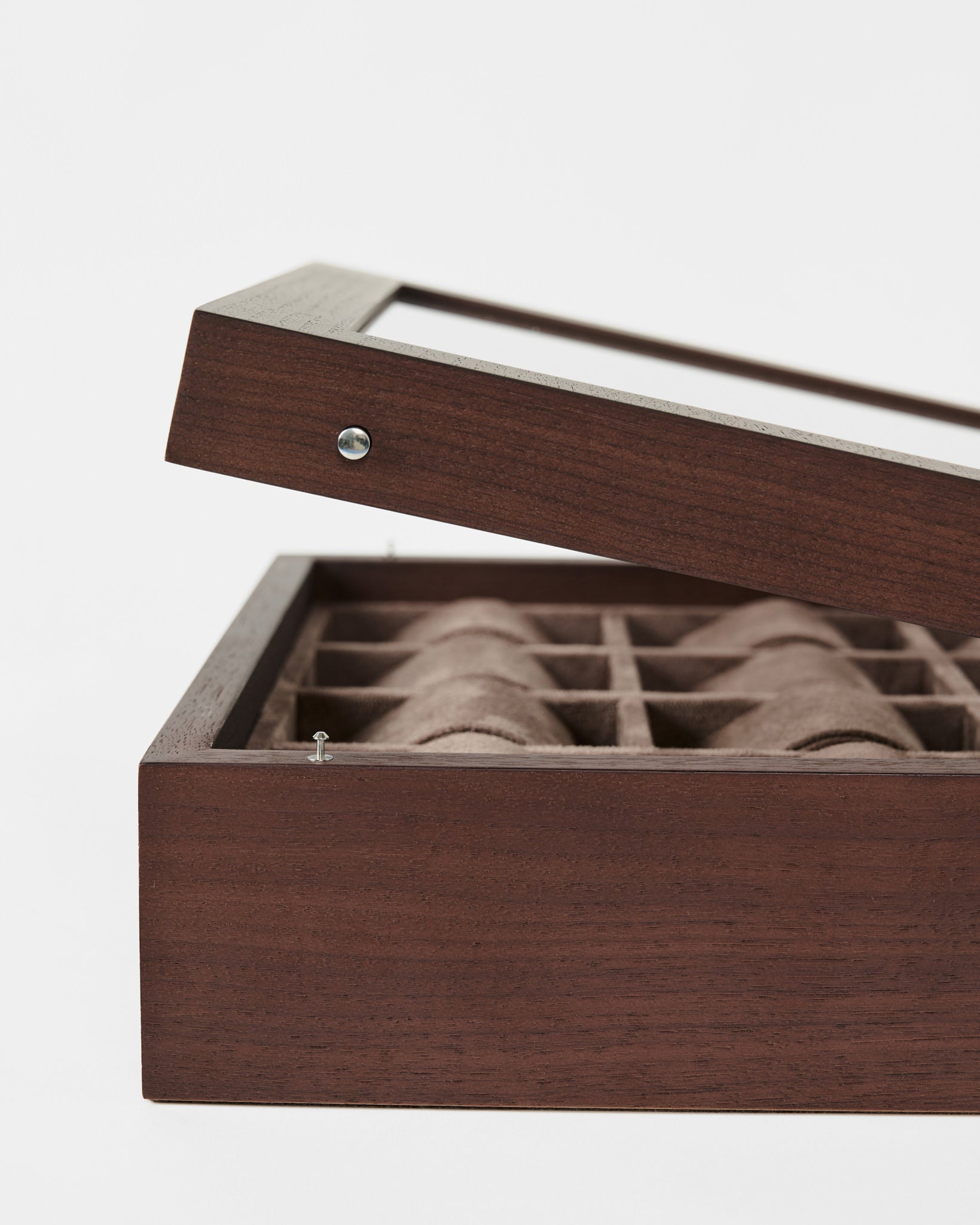 The TAWBURY Grove 12 Slot Wooden Watch Box in dark walnut features a glass lid and multiple cushioned compartments—perfect for collectors to stylishly display and protect their watches.