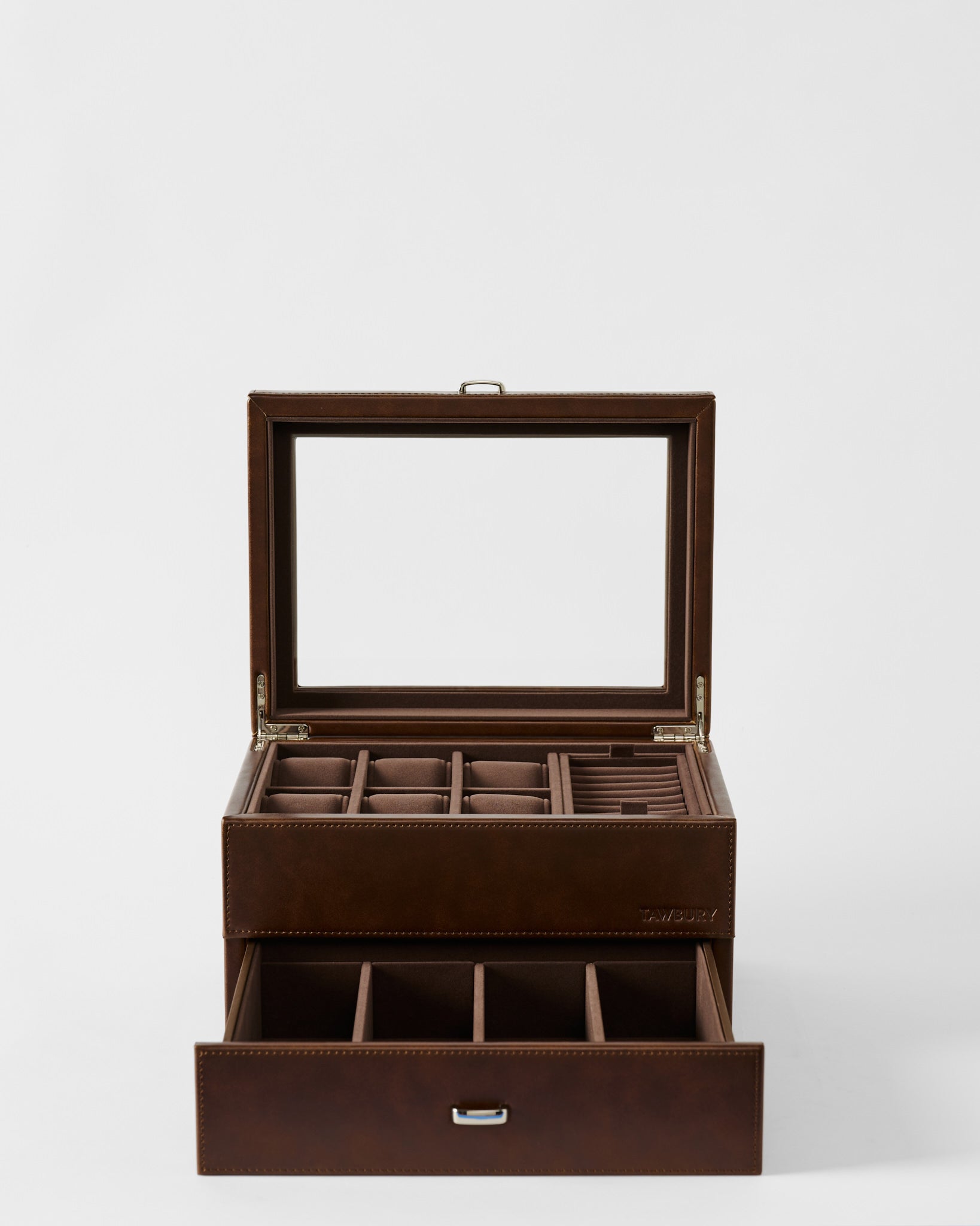 The TAWBURY Bayswater 6 Watch Jewelry Box in brown features a glass lid, multiple top compartments for watches, and an open drawer with additional divided sections for organized jewelry storage.