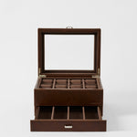 The TAWBURY Bayswater 8 Slot Watch Box with Storage in Chestnut Brown features a glass lid, eight watch compartments on top, and an open drawer with extra storage sections below.