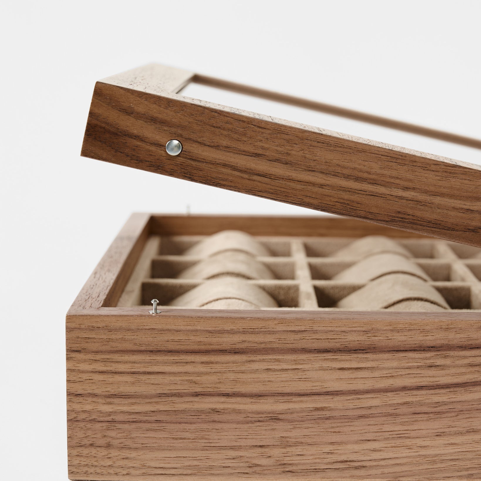 The TAWBURY Grove 12 Slot Wooden Watch Box in light walnut features a glass lid and multiple fabric-lined compartments—ideal for organizing your watches in style.