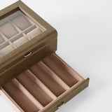 The TAWBURY Bayswater 8 Slot Watch Box with Storage in taupe features a glass lid, padded watch pillows on top, and a lower drawer with divided sections, displayed against a plain white background.