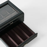 The TAWBURY Bayswater 8 Slot Watch Box with Storage in Black/Charcoal features a glass lid, an open drawer, and velvet-lined compartments for stylish watch and accessory display.