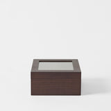 The TAWBURY Grove 6 Slot Wooden Watch Box in dark walnut wood features a glass lid and is displayed against a plain white background.