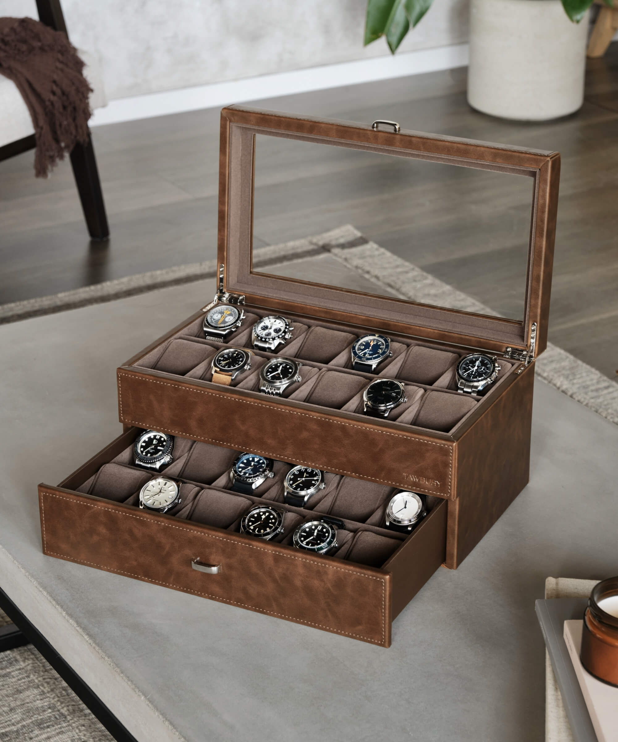 The TAWBURY Bayswater 24 Slot Watch Box with Drawer - Brown is a sleek brown leather box designed to protect and organise an extensive collection of watches. This premium box is perfect for watch enthusiasts looking to display their time.