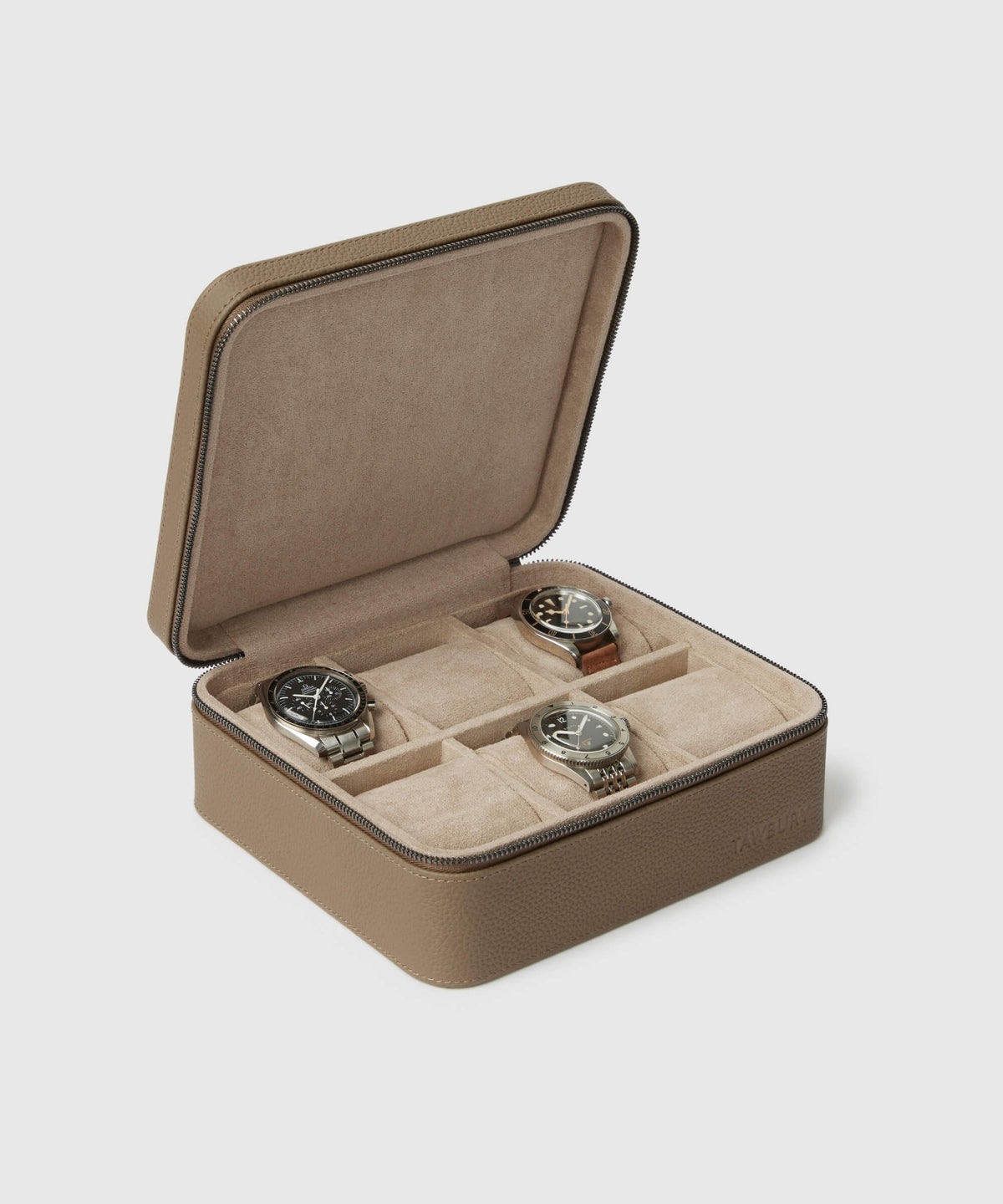 The Fraser 6 Watch Travel Case - Taupe by TAWBURY is open, showcasing three watches inside. The interior, lined with a suede-like fabric and divided into compartments to securely hold the watches, makes it an elegant solution for watch storage.