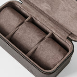 The TAWBURY Fraser 3 Watch Case - Brown is a rectangular leather travel case with a zipper and three compartments, each featuring a cushioned roll, perfect for organizing and protecting your watches on the go.