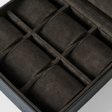 A close-up of the TAWBURY Fraser 6 Watch Case - Black, featuring six suede-lined compartments for organizing and storing watches or jewelry.