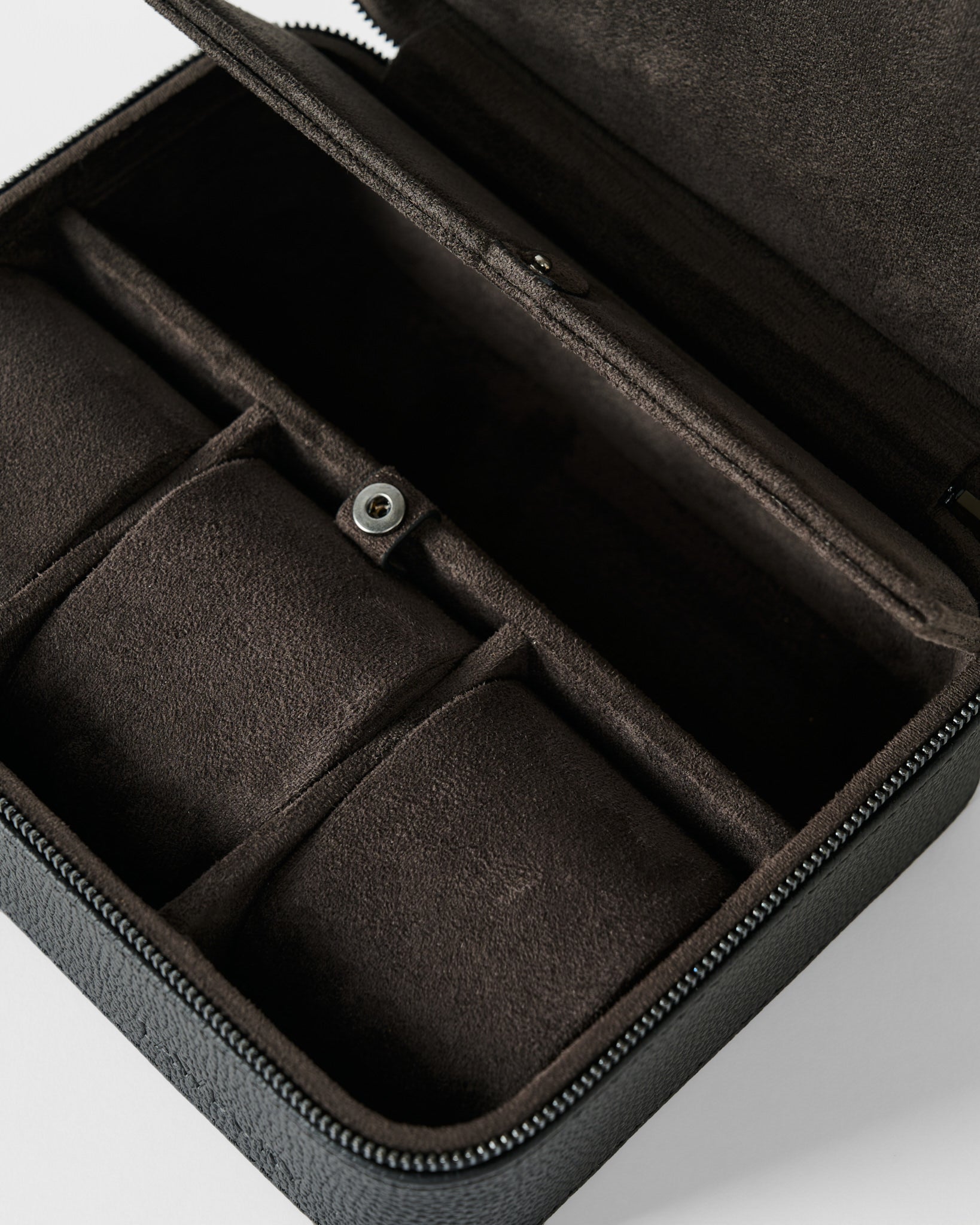 A close-up of the TAWBURY Fraser 3 Watch Case with Storage in black, featuring a soft, padded interior and compartments—ideal for securely storing watches or organizing jewelry.