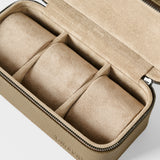The TAWBURY Fraser 3 Watch Case in taupe is a rectangular leather travel case with a zip closure, beige suede interior, and three padded sections for organizing your watches.