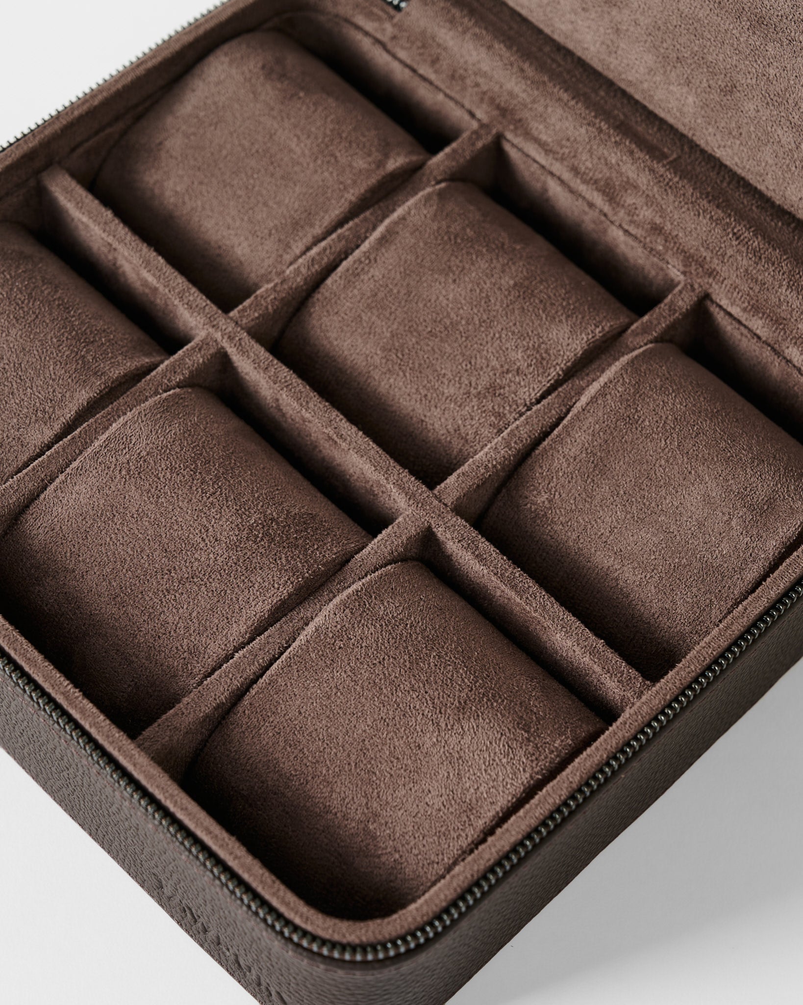 The TAWBURY Fraser 6 Watch Case - Brown features six cushioned compartments in a brown suede leather design, shown open and empty, ideal for storing and protecting watches or small accessories.
