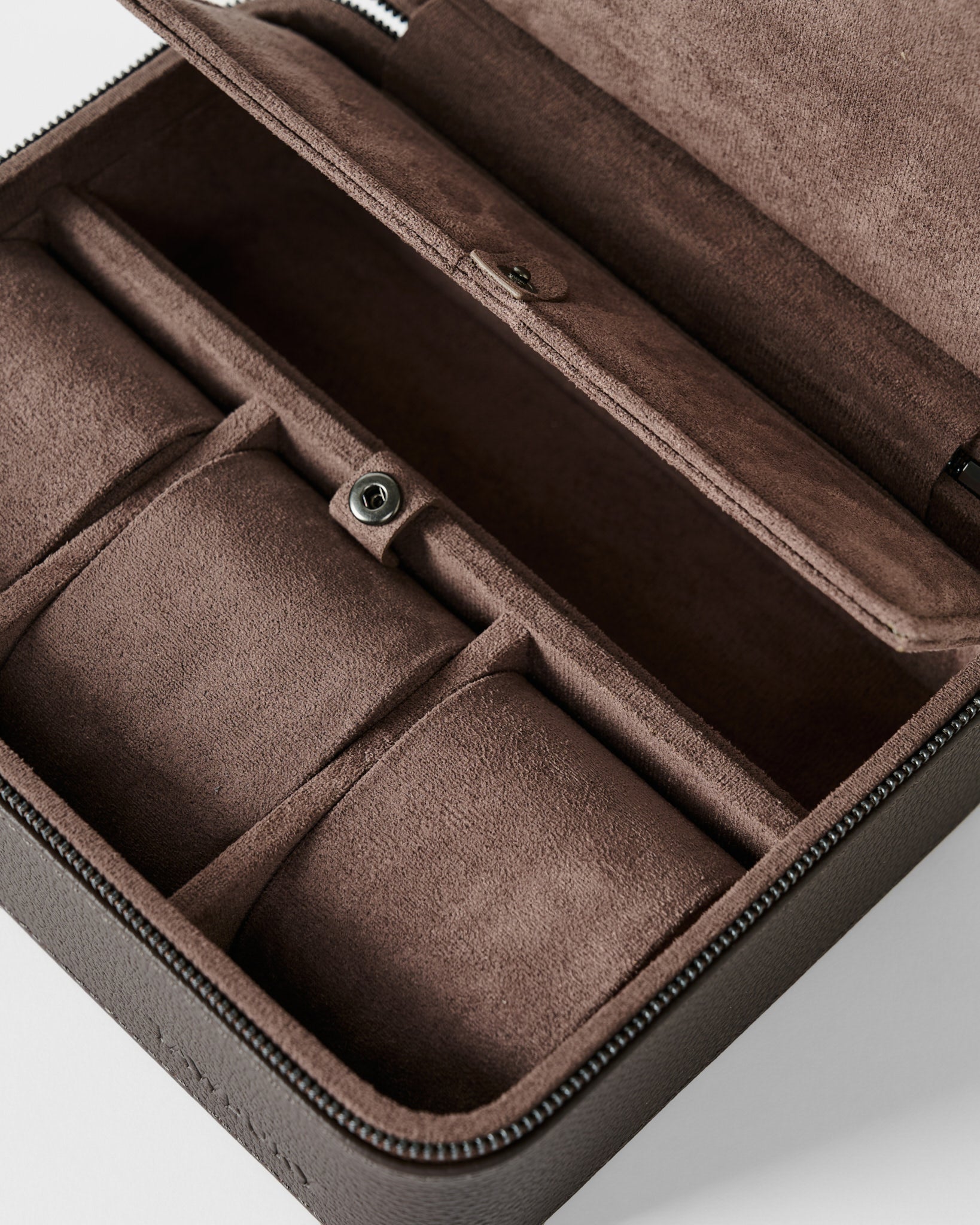 The TAWBURY Fraser 3 Watch Case with Storage in brown features a suede-lined interior, multiple compartments, and a snap-button closure, shown here in close-up.