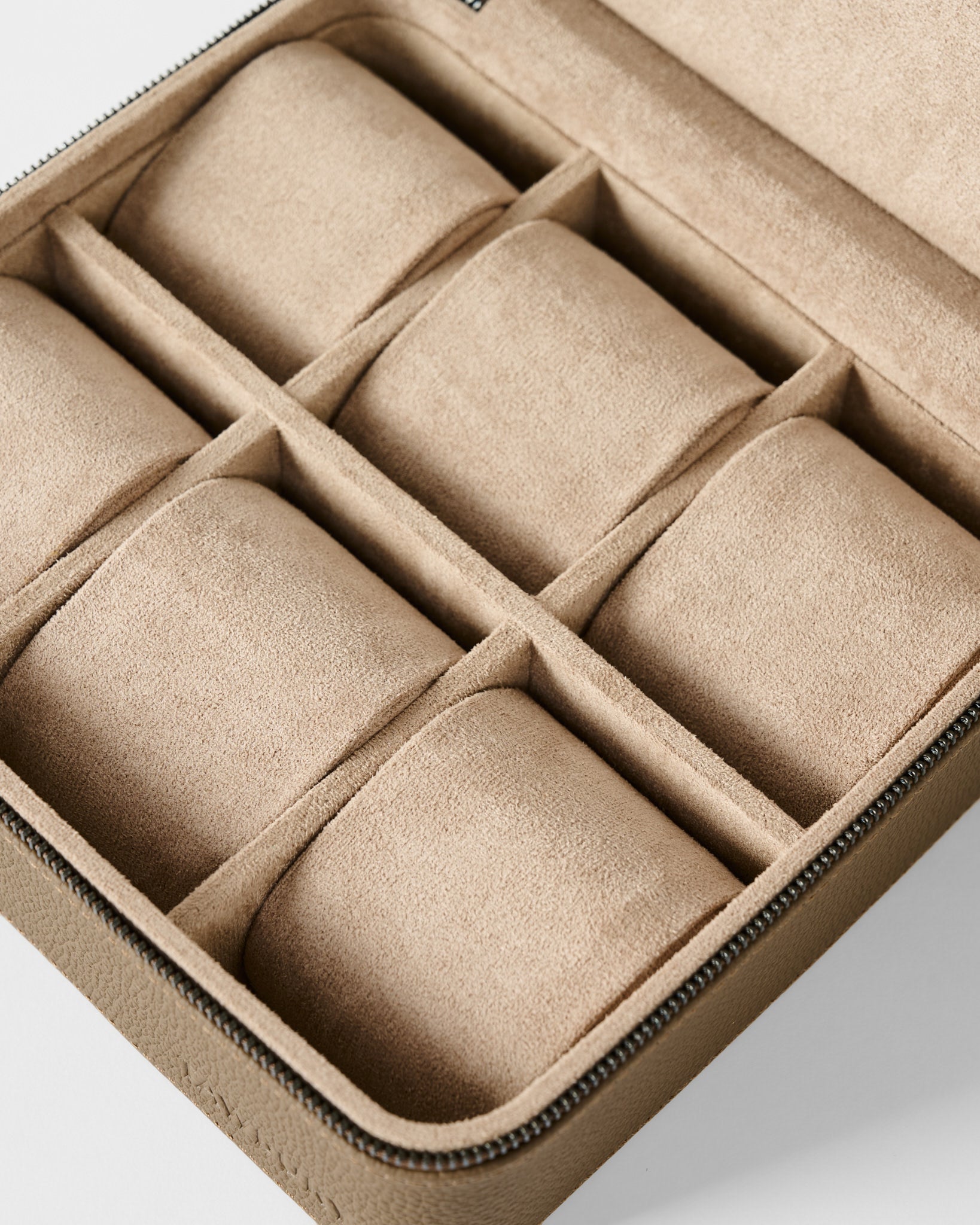 The TAWBURY Fraser 6 Watch Case in taupe offers six cushioned compartments and a zippered suede design—perfect for stylish watch or jewelry storage as an elegant alternative to a leather watch box.