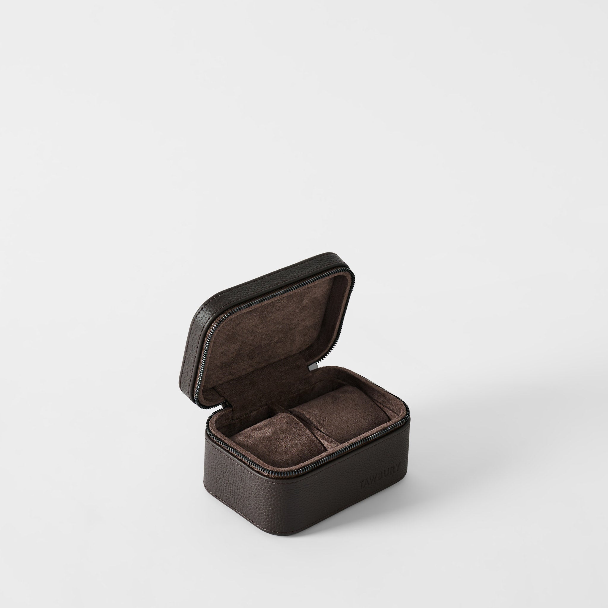 The TAWBURY Fraser 2 Watch Case in Espresso Brown is a compact square leather case with a hinged lid, opening to reveal two padded, soft-lined compartments for travel.