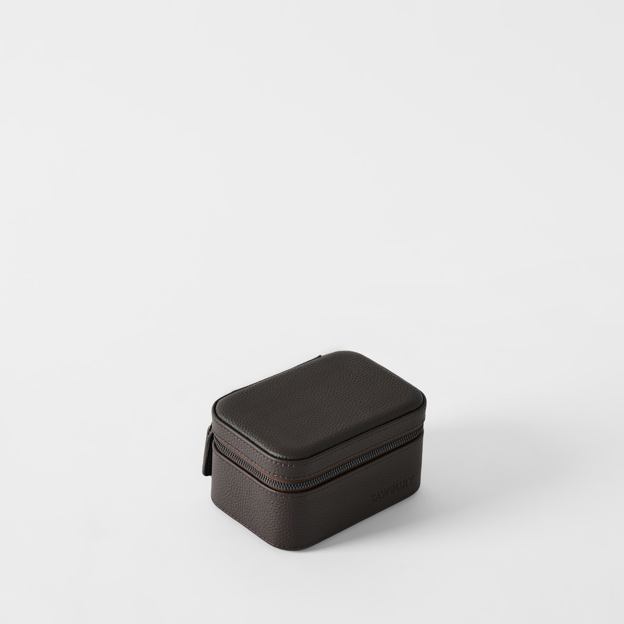 The TAWBURY Fraser 2 Watch Case in espresso brown features a small, rectangular design with textured leather and a zippered closure, displayed on a plain white background.