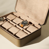 The TAWBURY Fraser 8 Watch Case in taupe features a soft beige interior; two watches are stored securely inside, with the other compartments remaining empty.