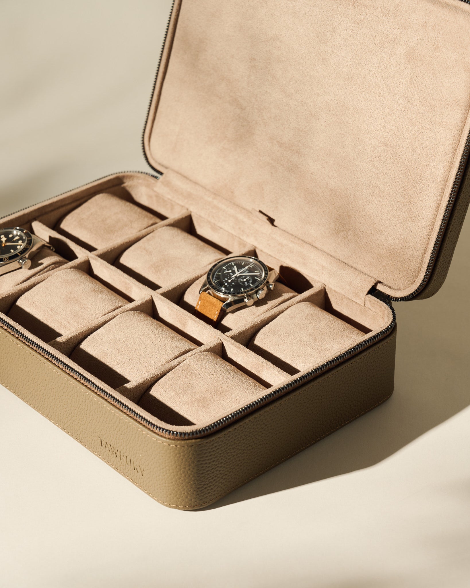 The TAWBURY Fraser 8 Watch Case in taupe features a soft beige interior; two watches are stored securely inside, with the other compartments remaining empty.