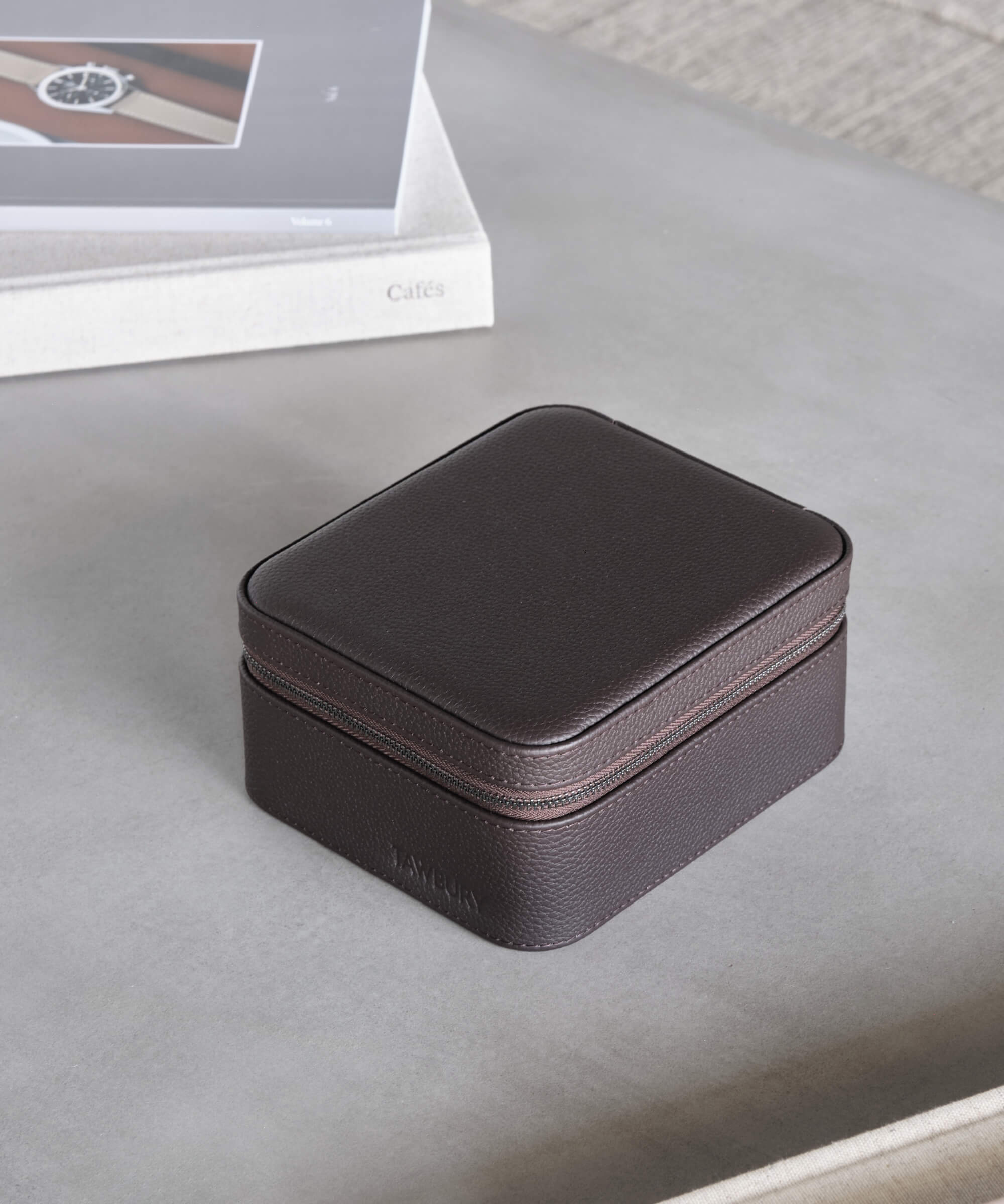 A Fraser 2 Watch Travel Case with Storage - Brown, provided by TAWBURY, is sitting on a table, providing protection for watches.