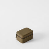 The TAWBURY Fraser 2 Watch Case in Truffle Taupe, a compact rectangular leather case with a textured finish and zipper, rests on a plain white background.