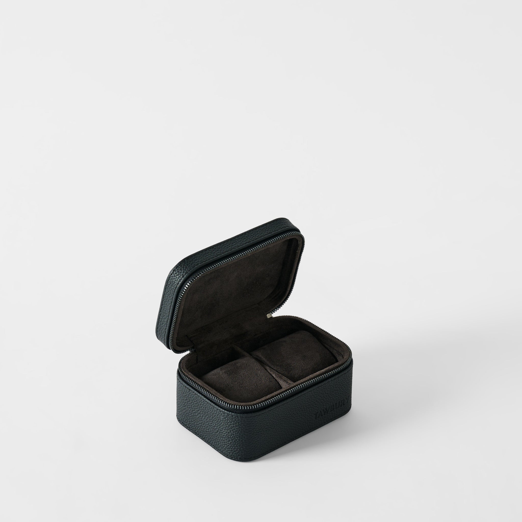The TAWBURY Fraser 2 Watch Case in Midnight Black is a small, rectangular case with a textured finish and zipper, opening to reveal two cushioned compartments for watches.