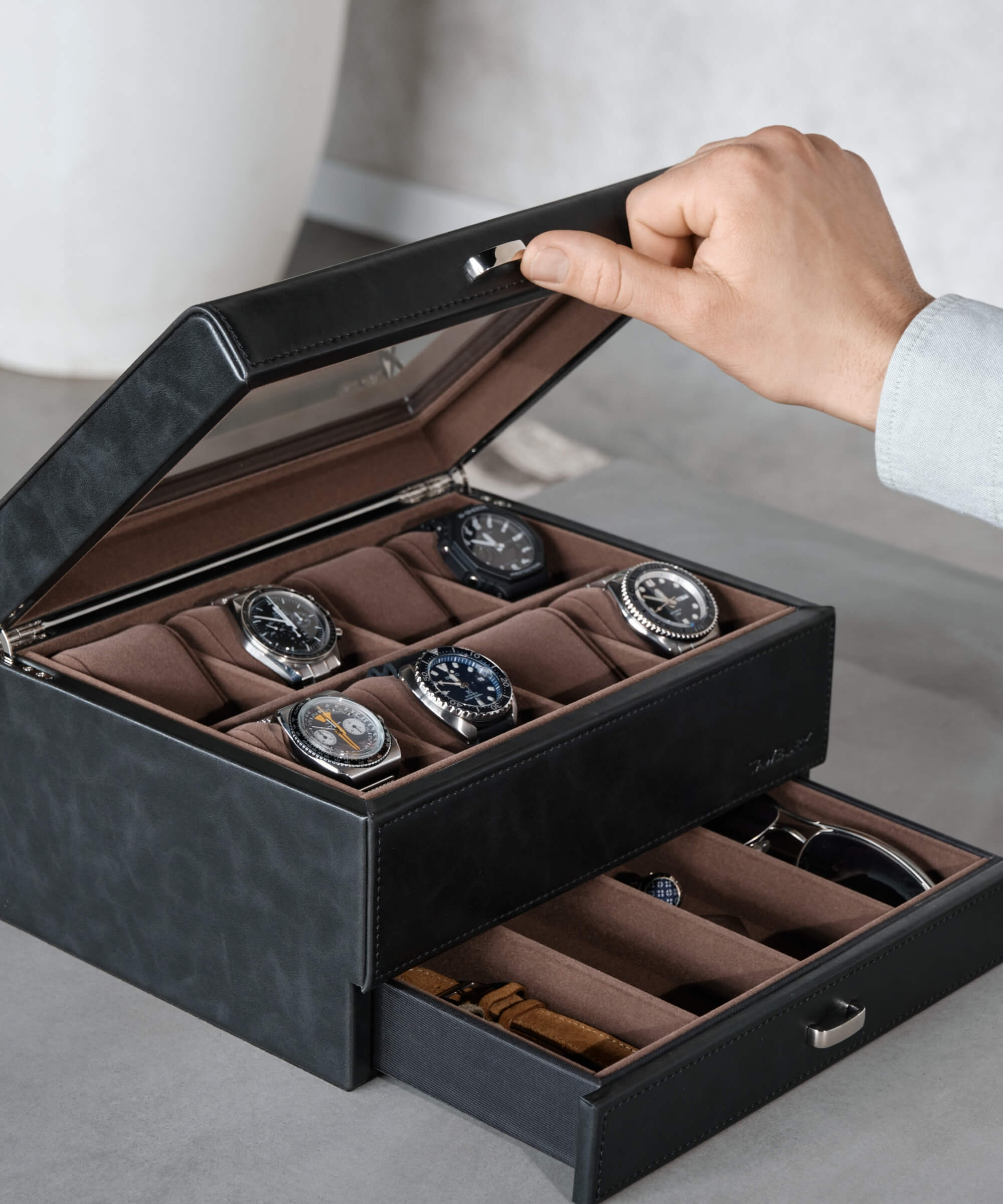 A hand opening a TAWBURY Bayswater 8 Slot Watch Box with Drawer - Black.