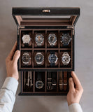 A person holding a TAWBURY Bayswater 8 Slot Watch Box with Drawer - Black.