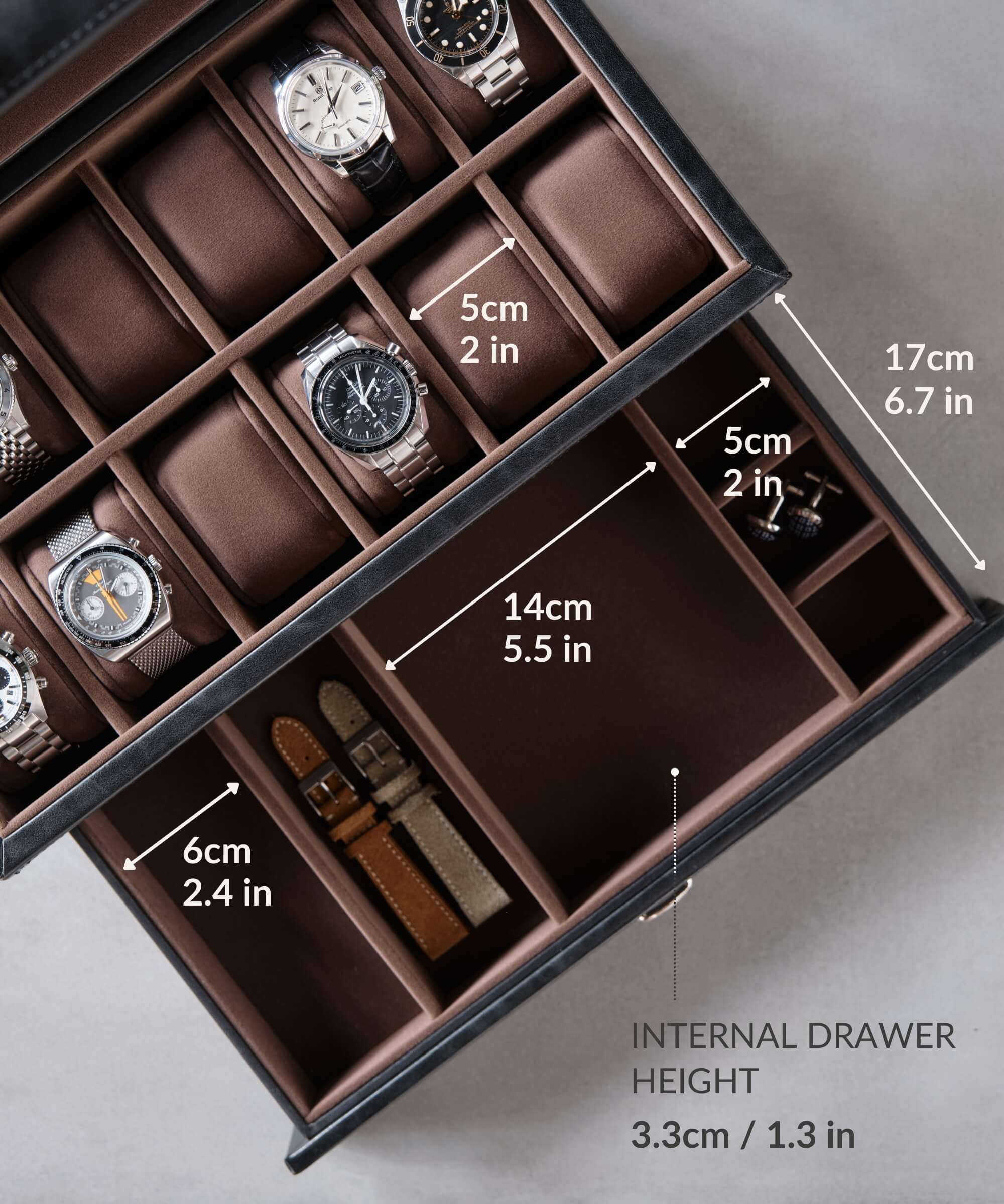 A TAWBURY Bayswater 12 Slot Watch Box with Drawer - Black with a number of timepieces in it for convenient storage.
