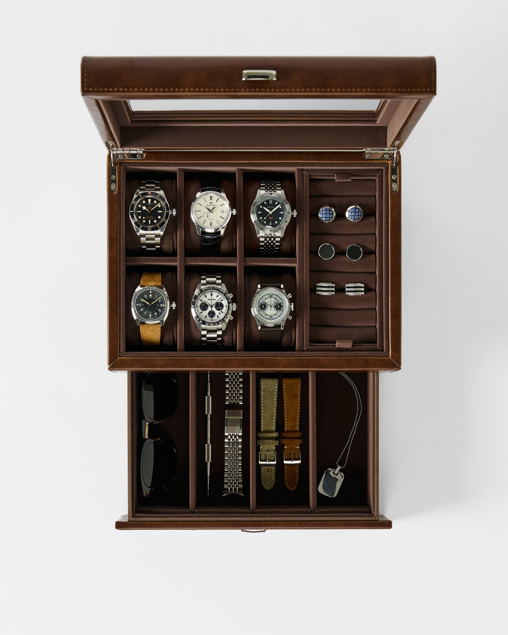 The TAWBURY Bayswater 6 Watch Jewelry Box in brown features compartments for six watches, cuffs, straps, a key, sunglasses, and a watch tool—offering elegant and organized watch storage.