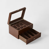 The TAWBURY Bayswater 6 Watch Jewelry Box in Chestnut Brown features a glass lid, top compartments for rings and small items, plus a spacious open drawer below for watch storage.