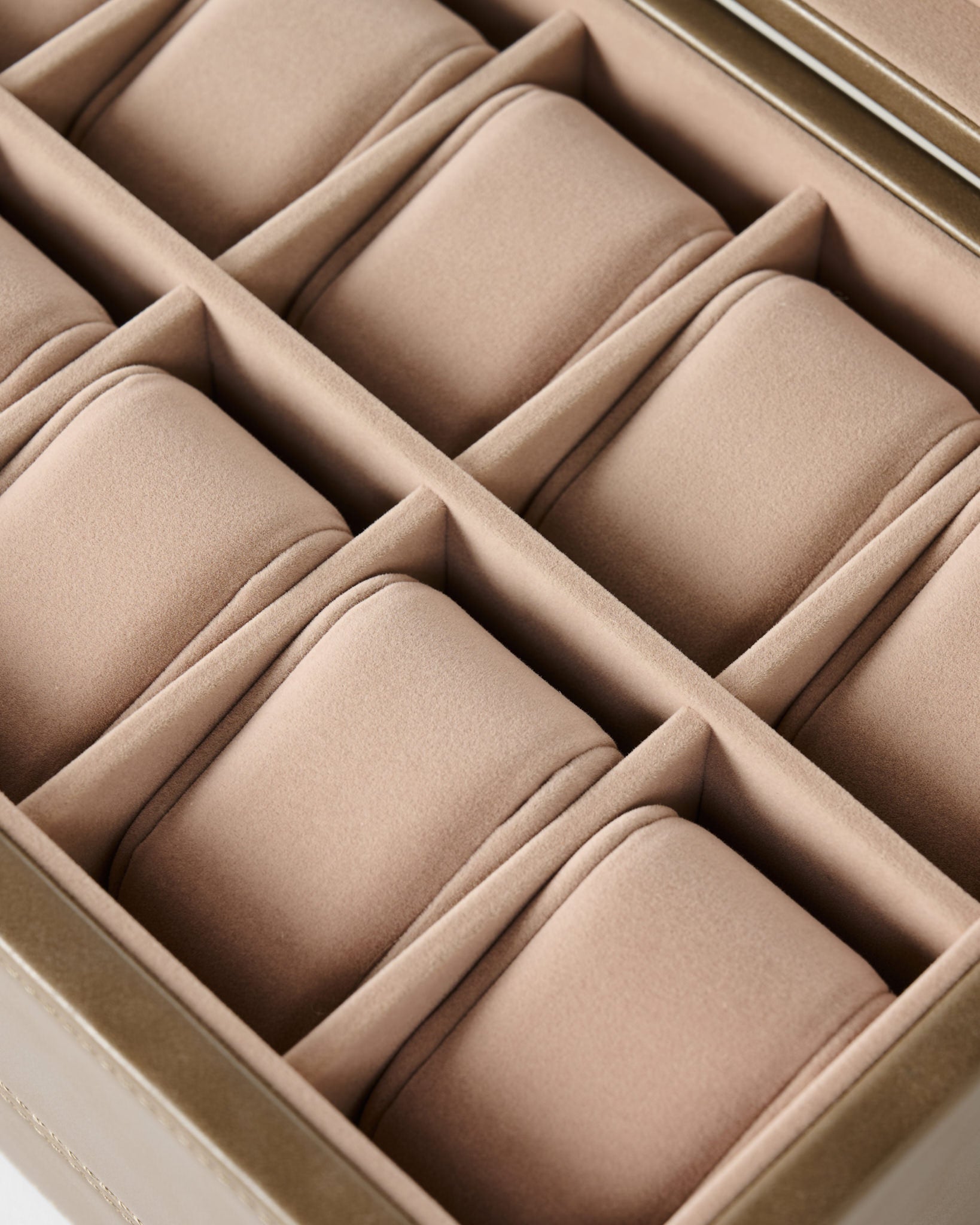 A close-up of the TAWBURY Bayswater 12 Slot Watch Box with Storage in taupe, featuring twelve padded compartments for elegant watch organization.