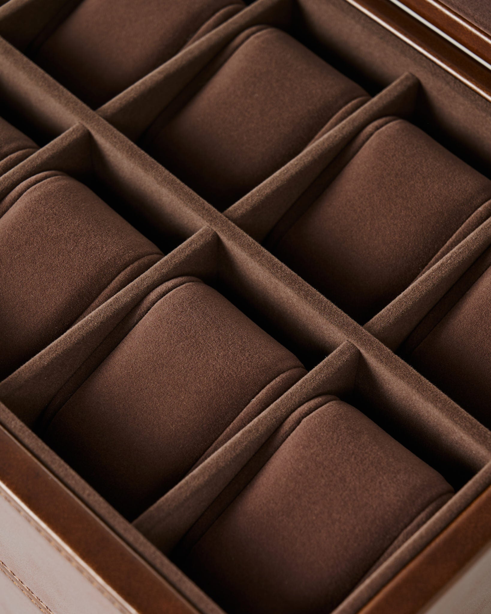 Close-up of the TAWBURY Bayswater 12 Slot Watch Box with Storage in brown, featuring a velvet-lined interior and individual padded compartments for elegant watch storage.