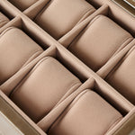 A close-up of the TAWBURY Bayswater 8 Slot Watch Box with Storage in taupe, featuring divided compartments and soft, cushioned pillows for watches.