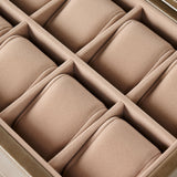 A close-up of the TAWBURY Bayswater 8 Slot Watch Box with Storage in taupe, featuring divided compartments and soft, cushioned pillows for watches.