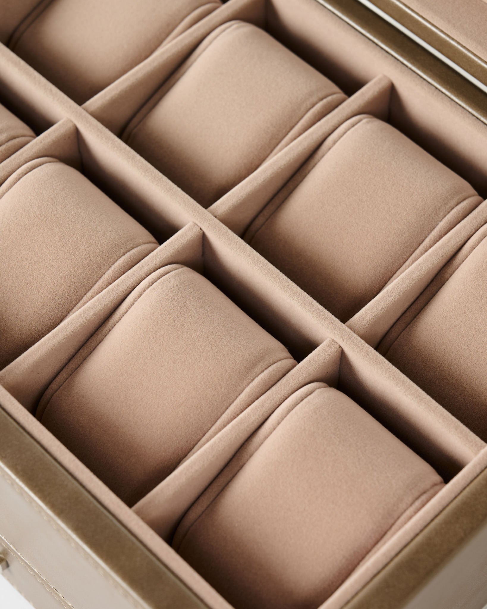 A close-up of the TAWBURY Bayswater 8 Slot Watch Box with Storage in taupe, featuring divided compartments and soft, cushioned pillows for watches.
