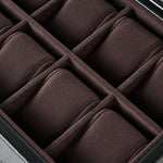 A close-up of the TAWBURY Bayswater 8 Slot Watch Box with Storage in Black/Charcoal, featuring velvet-lined, padded compartments arranged in two rows.