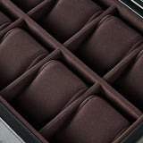A close-up of the TAWBURY Bayswater 8 Slot Watch Box with Storage in Black/Charcoal, featuring velvet-lined, padded compartments arranged in two rows.