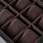 Close-up of the TAWBURY Bayswater 24 Slot Watch Box with Drawer in Black/Charcoal, featuring multiple brown cushioned compartments—ideal for stylish watch storage and display.