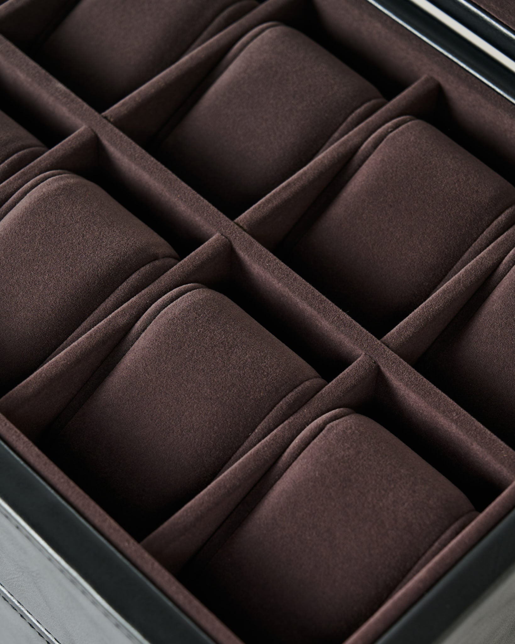 Close-up of the TAWBURY Bayswater 24 Slot Watch Box with Drawer in Black/Charcoal, featuring multiple brown cushioned compartments—ideal for stylish watch storage and display.