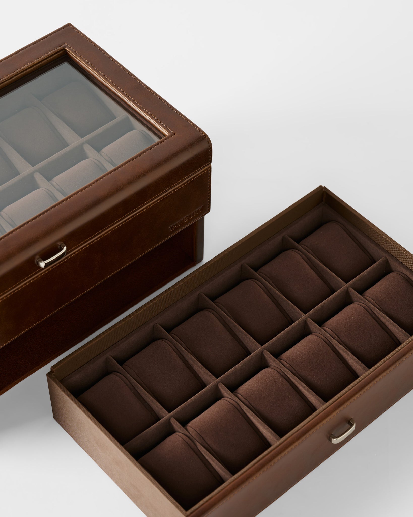 The TAWBURY Bayswater 24 Slot Watch Box with Drawer in brown features a glass lid and multiple cushioned compartments—ideal for organizing and displaying your collection.