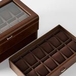 The TAWBURY Bayswater 24 Slot Watch Box with Drawer in brown features a glass lid and multiple cushioned compartments—ideal for organizing and displaying your collection.